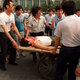 Local residents loaded wounded on rickshaw flatbeds shortly after soldiers opened fire on the crowd.